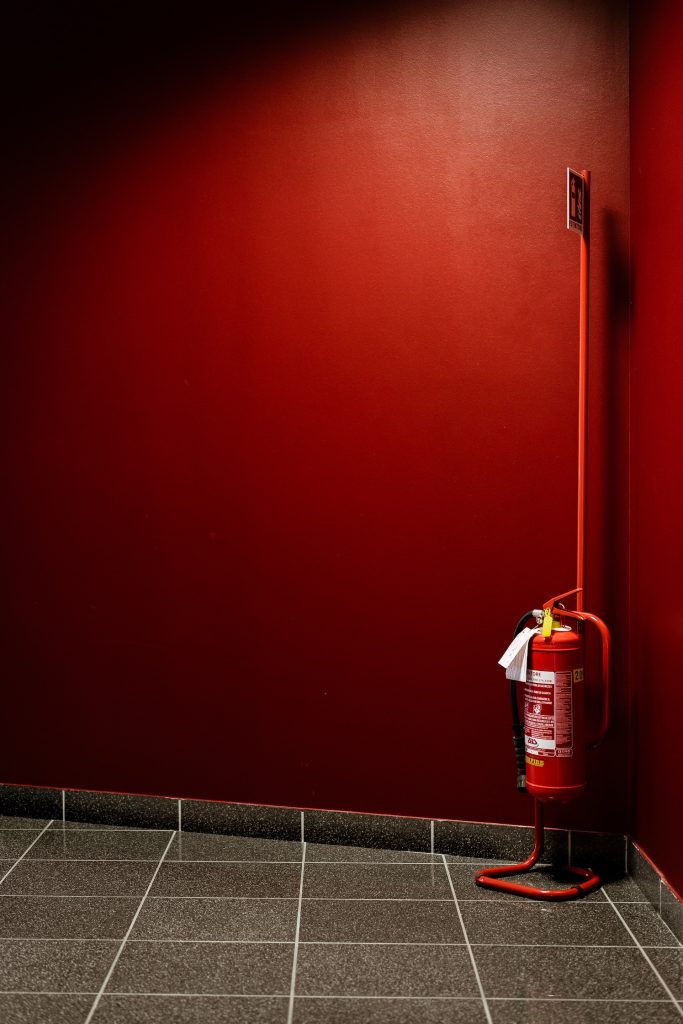 red fire extinguisher on corner